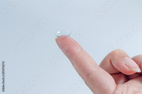 Contact lens close-up on a woman’s fingertip. Good vision