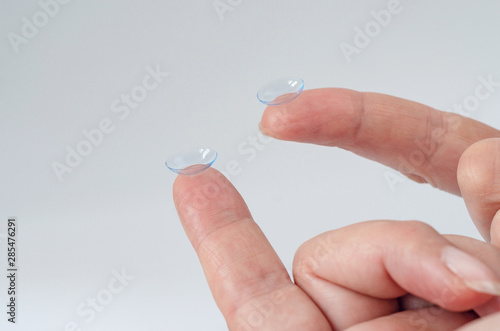 Contact lens close-up on a woman   s fingertip. Good vision