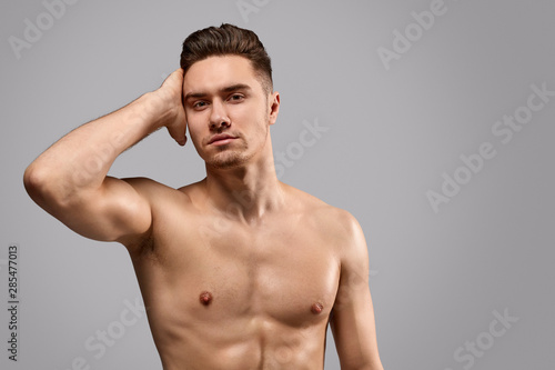 Fit young man touching hair