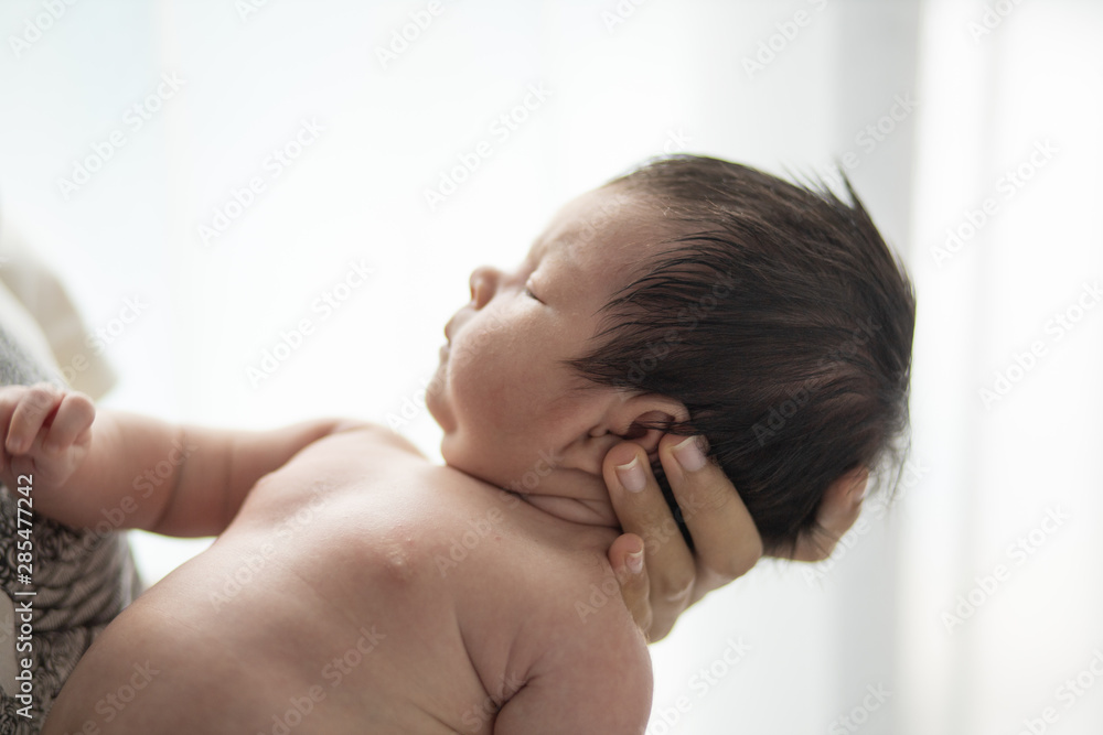 Asian Little girl newborn on mother hand Asian Little girl newborn on mother hand