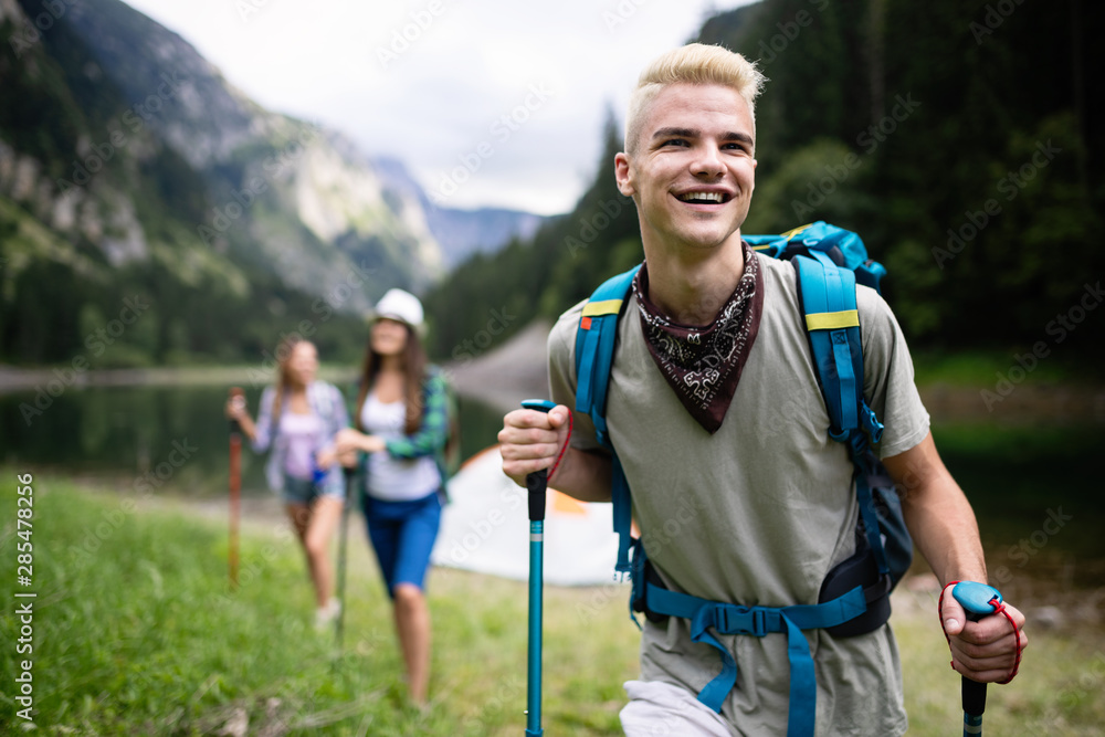 Hiking with friends is so fun. Group of young people with backpacks hiking together Hiking with friends is so fun. Group of young people with backpacks hiking together