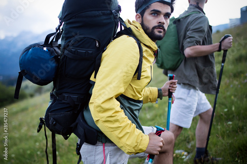 Man traveling with backpack hiking in mountains