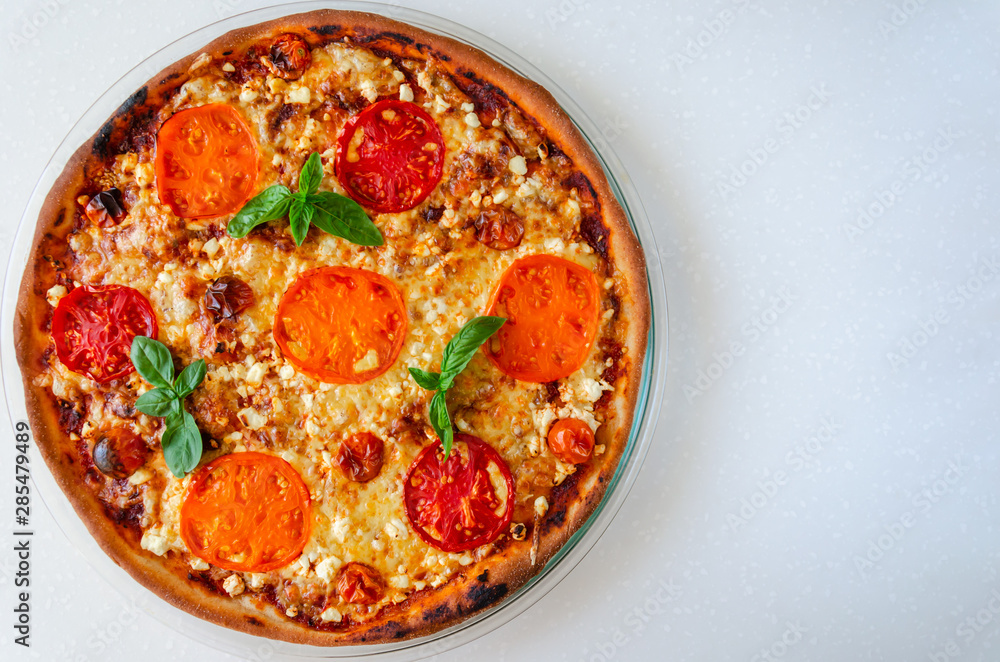 Pizza Margherita with yellow, red and cherry tomatoes, mozzarella cheese, ricotta and fresh basil on white background Pizza Margherita with yellow, red and cherry tomatoes, mozzarella cheese, ricotta and fresh basil on white background