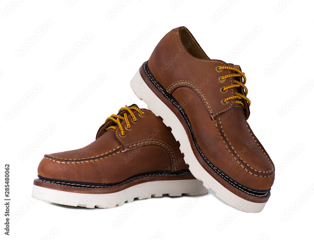 Man fashion close-up a pair of brown shoes isolated on a white background. Man fashion close-up a pair of brown shoes isolated on a white background.