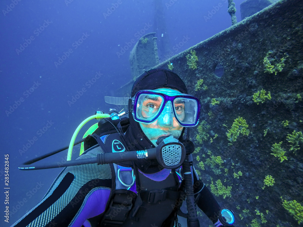 Scuba Diver Portrait Beside Large Shipwreck