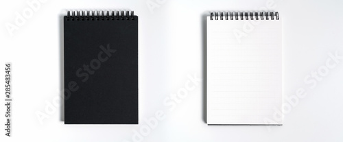 Notebook mock up with clean black blank for design and advertising. Notepad with chromed spring and free copy space template. On the gray background.