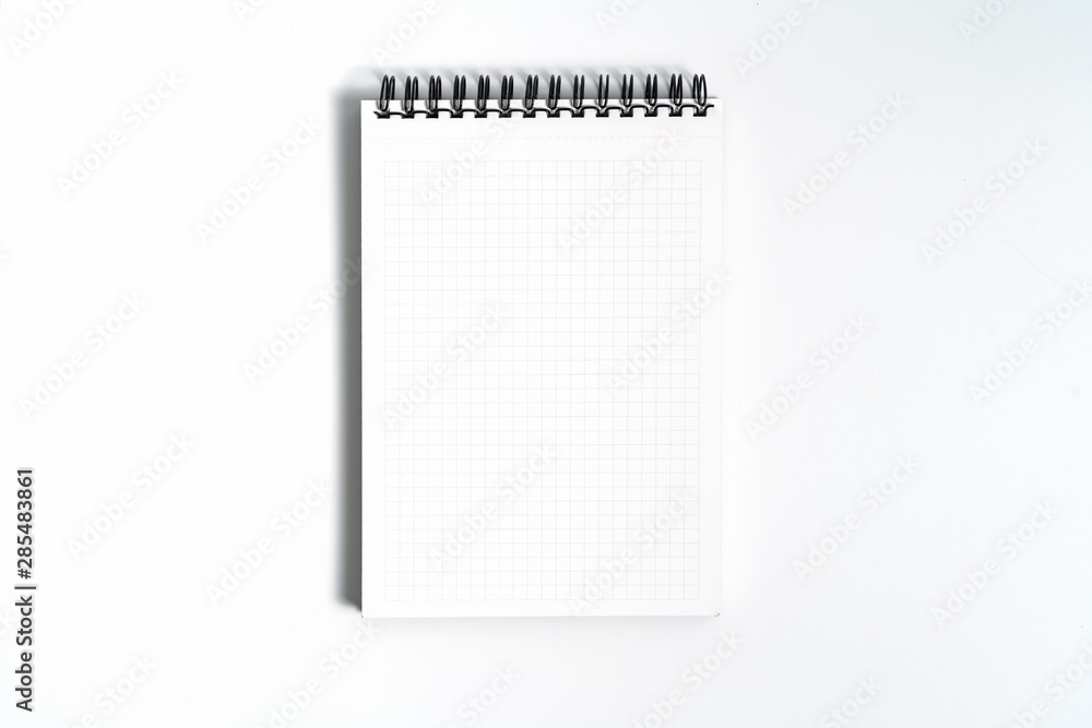 Notebook mock up with clean black blank for design and advertising. Notepad with chromed spring and free copy space template. On the gray background. Notebook mock up with clean black blank for design and advertising. Notepad with chromed spring and free copy space template. On the gray background.