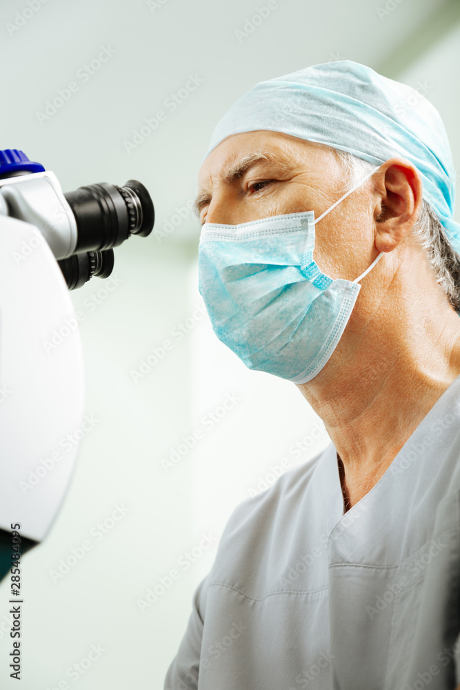 Nice experienced eye doctor being at work Nice experienced eye doctor being at work