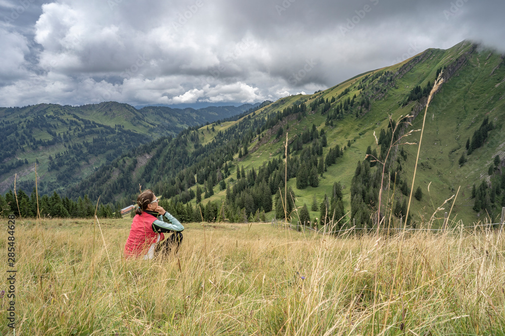 senior woman hiking in autumnal atmosphere on the ridge of the Nagelfluh chain near Oberstaufen, Allgaeu area, Bavaria, Germany senior woman hiking in autumnal atmosphere on the ridge of the Nagelfluh chain near Oberstaufen, Allgaeu area, Bavaria, Germany
