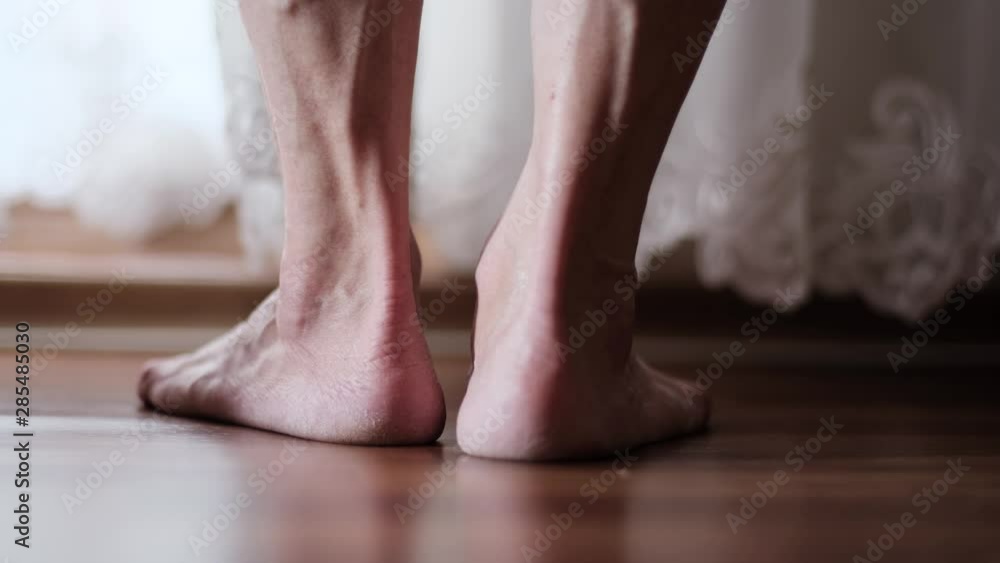 Legs of an elderly woman with varicose veins on the floor close up. Legs of an elderly woman on the floor by the window. concept of suicide, depression, loneliness, pain in old age Legs of an elderly woman with varicose veins on the floor close up. Legs of an elderly woman on the floor by the window. concept of suicide, depression, loneliness, pain in old age