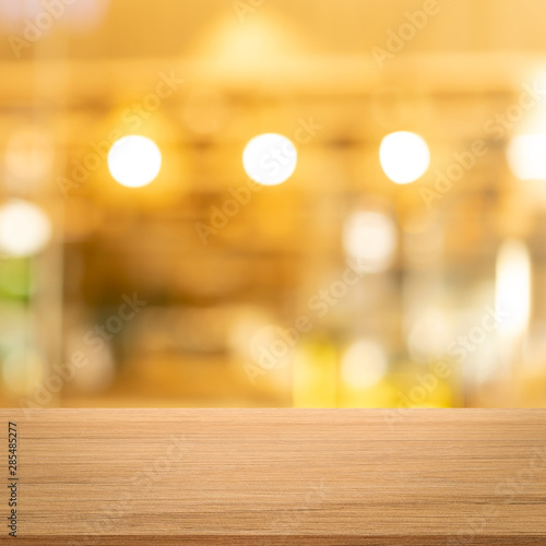 abstract blurred modern interior restaurant cafe shop decorate with bulbs lamp light on ceiling and wood counter table perspective square background for show  promote  advertise product on display 