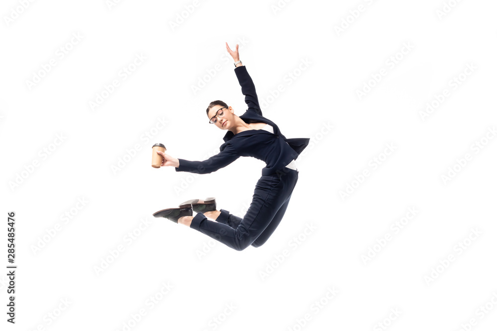 graceful businesswoman holding paper cup while dancing isolated on white