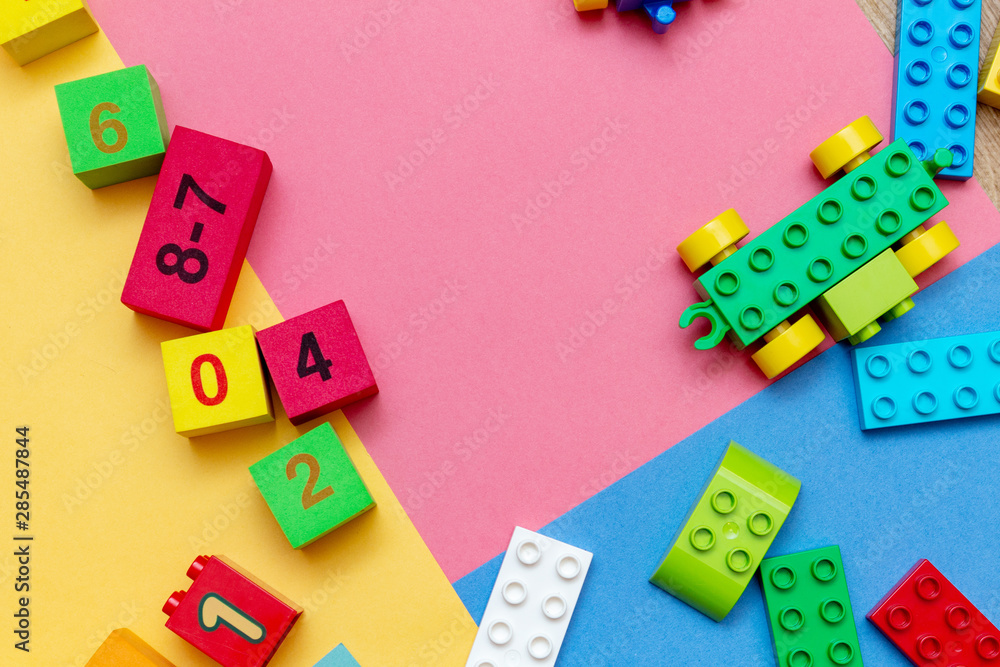 child kid colorful education toys cubes with numbers math pattern background on the bright background. Flat lay. Childhood infancy children babies concept. child kid colorful education toys cubes with numbers math pattern background on the bright background. Flat lay. Childhood infancy children babies concept.