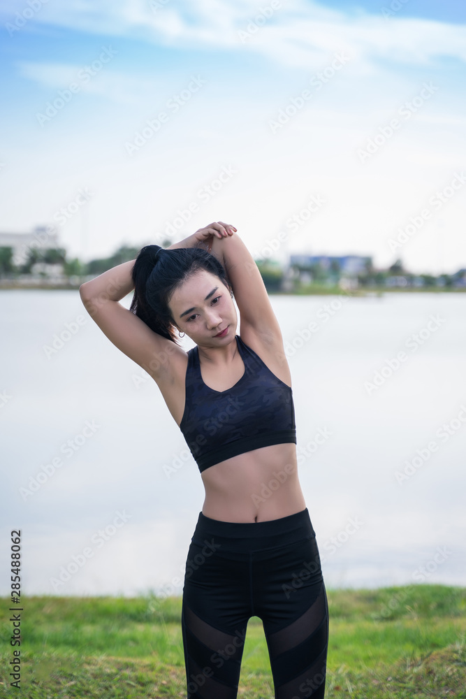 Serious Beautiful Female in Sportswear Doing Exercise Outdoors