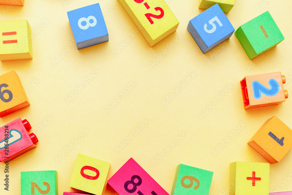 child kid colorful education toys cubes with numbers math pattern background on the bright background. Flat lay. Childhood infancy children babies concept. child kid colorful education toys cubes with numbers math pattern background on the bright background. Flat lay. Childhood infancy children babies concept.