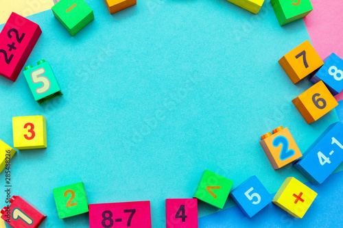 child kid colorful education toys cubes with numbers math pattern background on the bright background. Flat lay. Childhood infancy children babies concept.