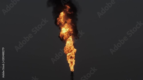 Gas flare and smoke of petrochemical refinery at twilight