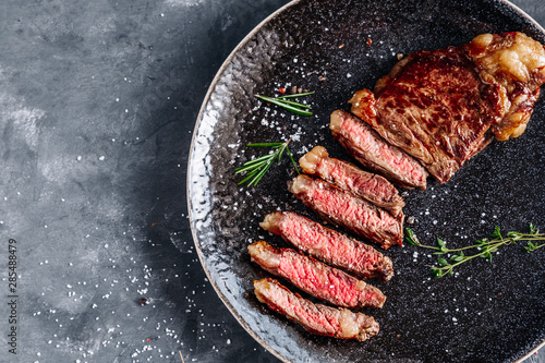 New York Strip steak medium rare with rosemary top view 