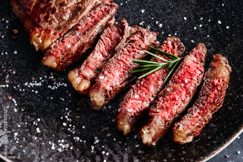 New York sirloin beef steak medium rare with rosemary top view 
