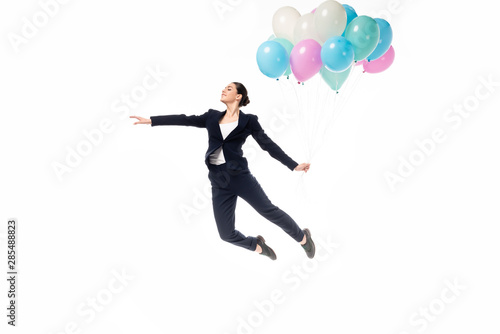 Vászonkép happy businesswoman levitating with festive balloons isolated on white