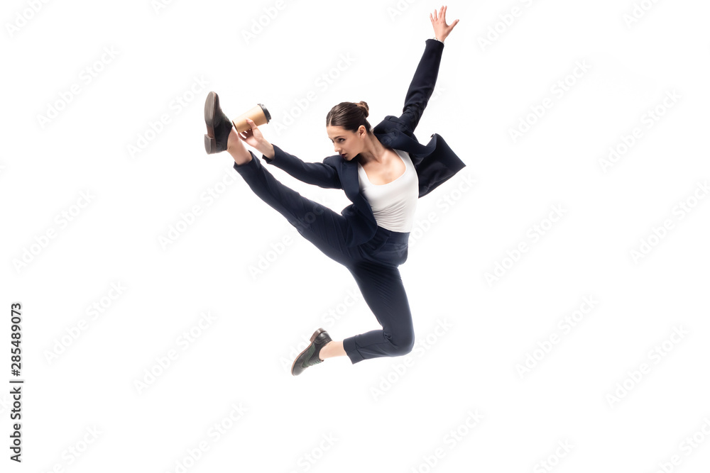young businesswoman jumping in dance while golding paper cup isolated on white