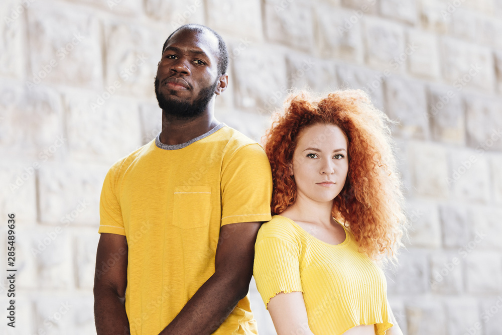 Medium shot of interracial couple matching clothes
