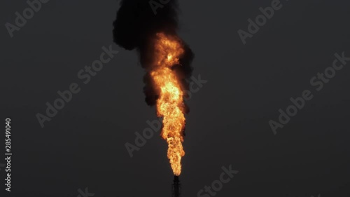 Gas flare and smoke of petrochemical refinery in twilight