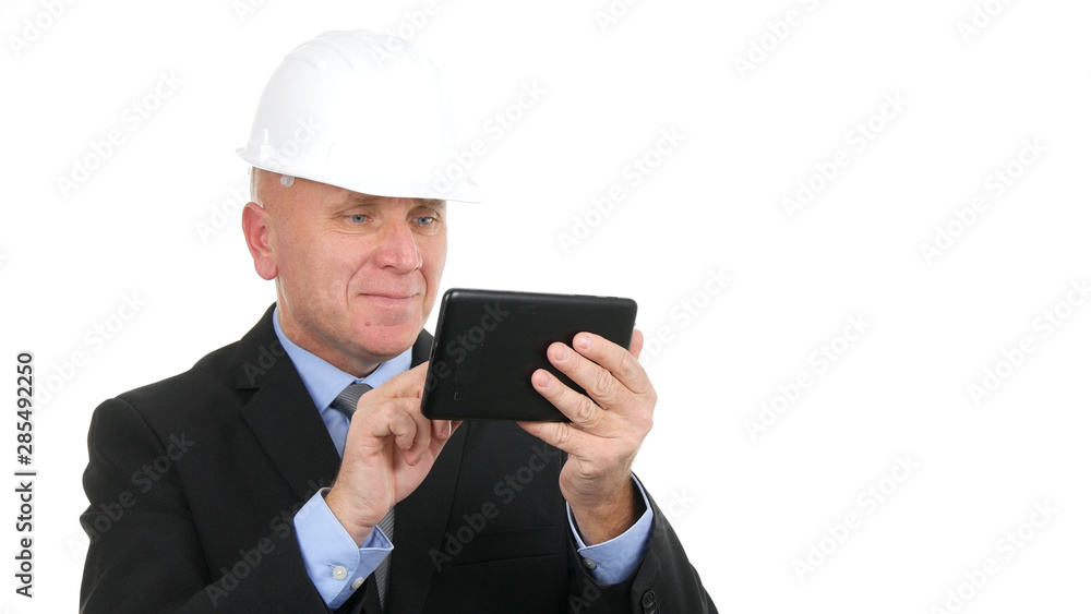 Businessman with Hardhat Smile and Text Using Electronic Tablet 