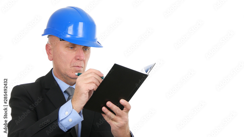 Image with Engineer Reading and Writing in Agenda Technical Notes Image with Engineer Reading and Writing in Agenda Technical Notes