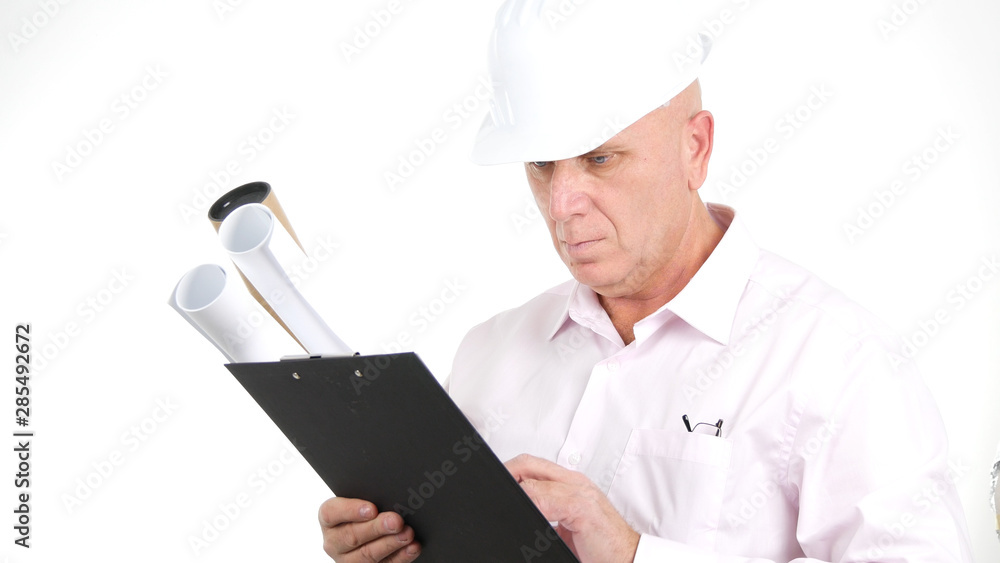 Image with Engineer Reading Technical Plans for a Building Construction Image with Engineer Reading Technical Plans for a Building Construction