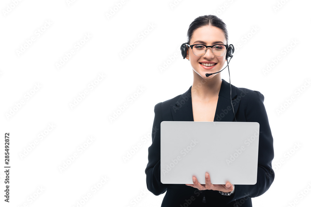 smiling call center operator in headset using laptop while looking at camera isolated on white smiling call center operator in headset using laptop while looking at camera isolated on white