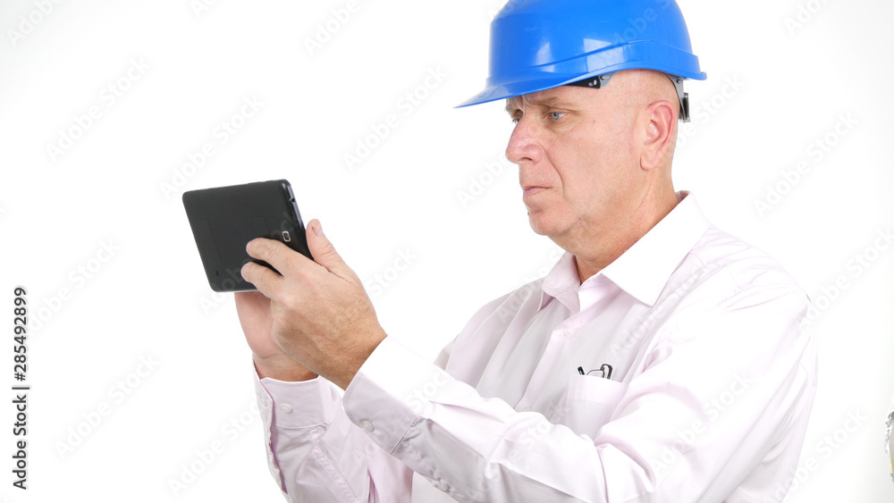 Image with Engineer Reading and Writing Messages Using Electronic Tablet Image with Engineer Reading and Writing Messages Using Electronic Tablet