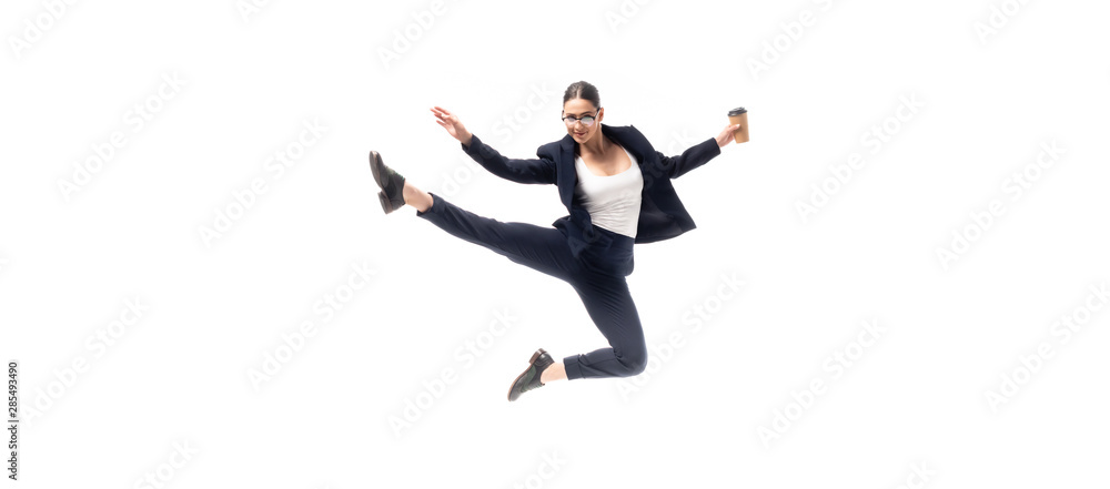 panoramic shot of young businesswoman dancing with coffee to go isolated on white