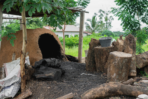  Charcoal kiln and wood placed near photo