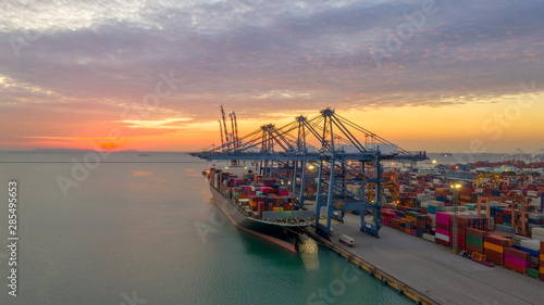 Container ship in export and import business logistics and transportation. Cargo and container box shipping to harbor by crane. Water transport International. Aerial view and top view.