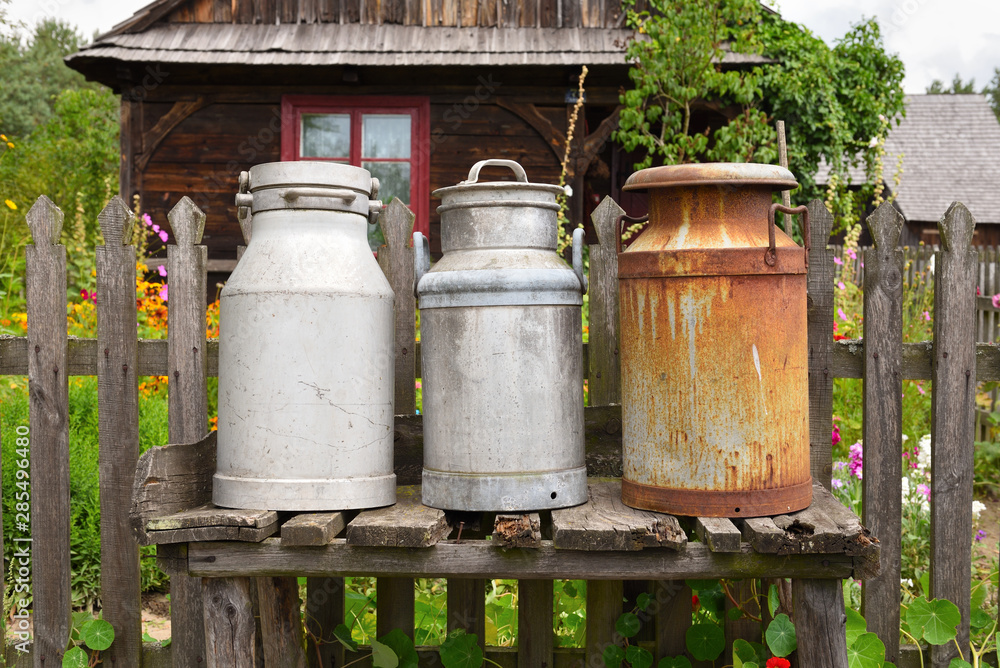 Obraz premium Old milk cans in The Folk Culture Museum in Osiek by the river Notec, the open-air museum presents polish folk culture. Poland, Europe