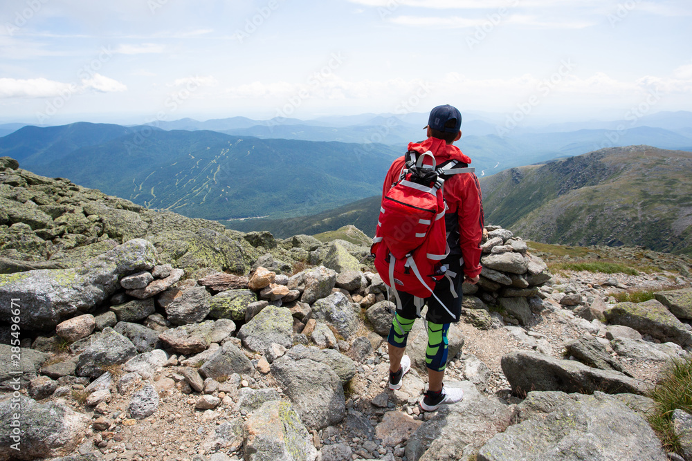 Young sporty and athletic man hiking to summit of Mount Washington in New Hampshire