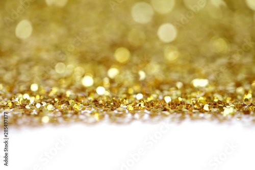 Gold (bronze) glitter shine dots confetti. Abstract light blink sparkle defocus backgound.