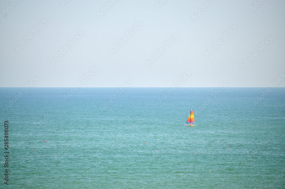 Sailboat sails gently on the sea