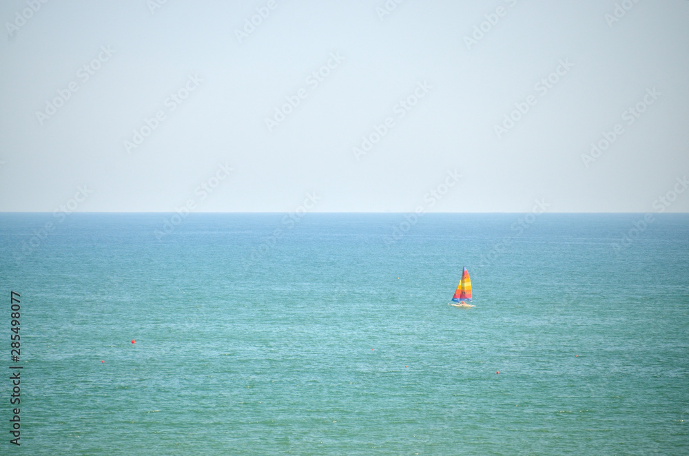 Sailboat sails gently on the sea