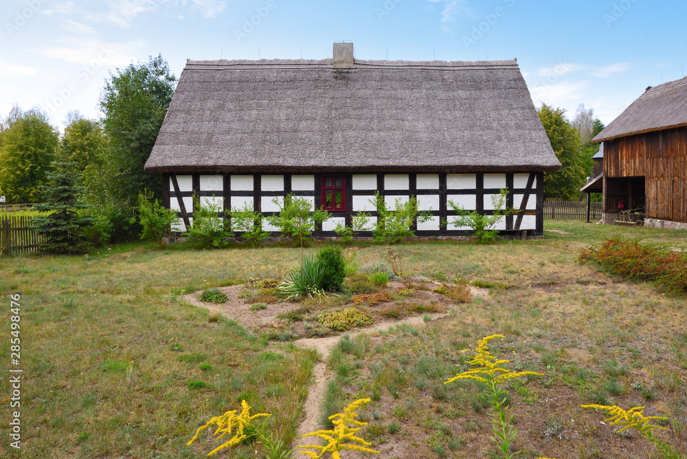 Old whitewashed house in The Folk Culture Museum in Osiek by the river Notec, the ethnographic park covers an area of 13 ha. Poland, Europe