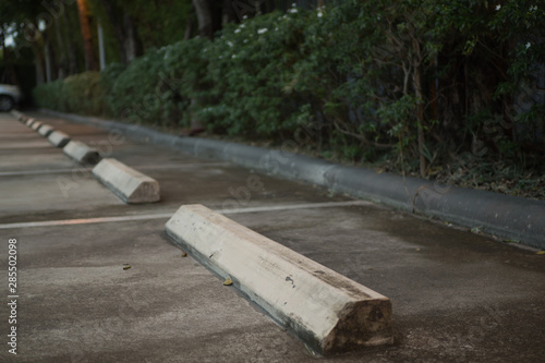 Concrete wheel stopper at outdoor car parking 