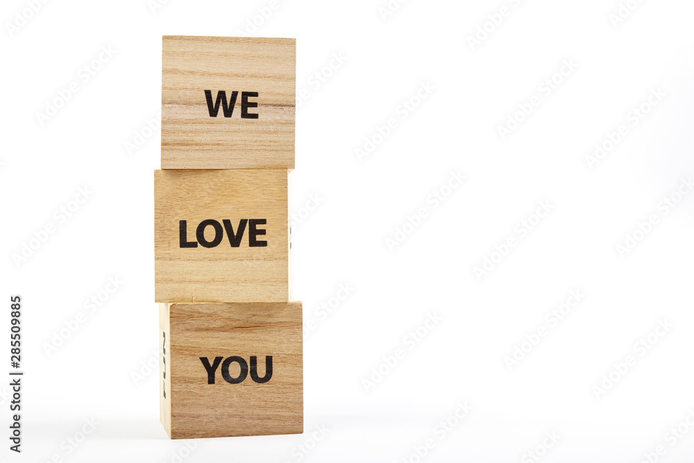 Wooden cubes with the inscription we love you on a white background Wooden cubes with the inscription we love you on a white background