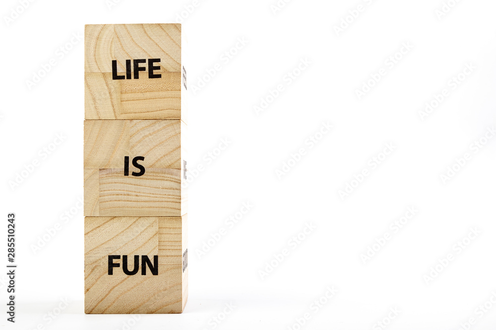 Wooden cubes with the inscription life is fun on a white background Wooden cubes with the inscription life is fun on a white background