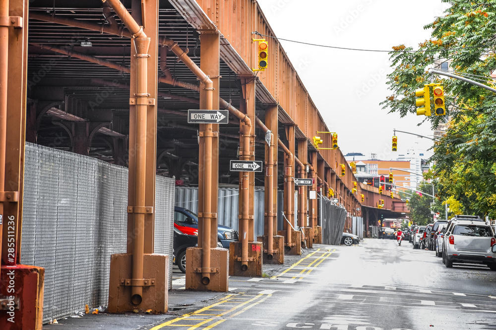 Obraz premium Bottom view of Elevated train track nyc. Buildings in the background in a foggy day. NYC, USA.