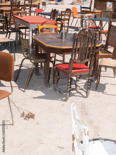different vintage street tables and chairs in a cafe outdoor second hand © OceanProd