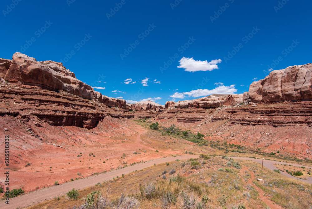 Landscape of red stone bluffs in a canyon in Bluff, Utah