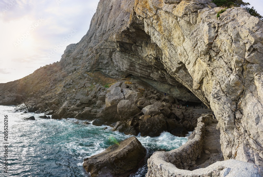 Golitsyn grotto (Pop, Chaliapin grotto) — a large natural grotto, knocked out by sea waves in the mountain Koba-Kaya (Cave) near the village of Novy Svet in the Crimea - a tourist attraction Golitsyn grotto (Pop, Chaliapin grotto) — a large natural grotto, knocked out by sea waves in the mountain Koba-Kaya (Cave) near the village of Novy Svet in the Crimea - a tourist attraction