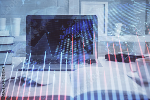 Stock market chart hologram drawn on personal computer background. Multi exposure. Concept of investment. © peshkova