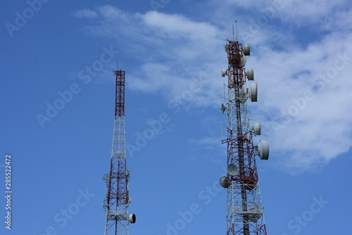 Microwave system.Wireless Communication Antenna With bright sky.Telecommunication tower with antennas.High pole for signal transmission. © tharathip